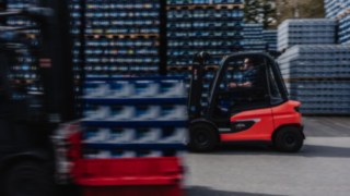 The X30 electric forklift truck is traveling quickly across an outdoor area.