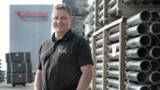 Marco Schillmöller stands in front of the Gebr. Ostendorf Plastics building in Vechta.