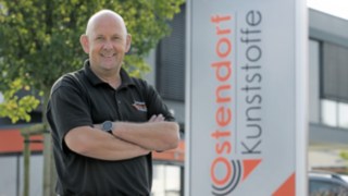 Uwe Fröhle stands in front of the Gebr. Ostendorf GmbH building in Vechta, Germany.