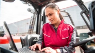 Service technician carrying out error diagnostics on their laptop.